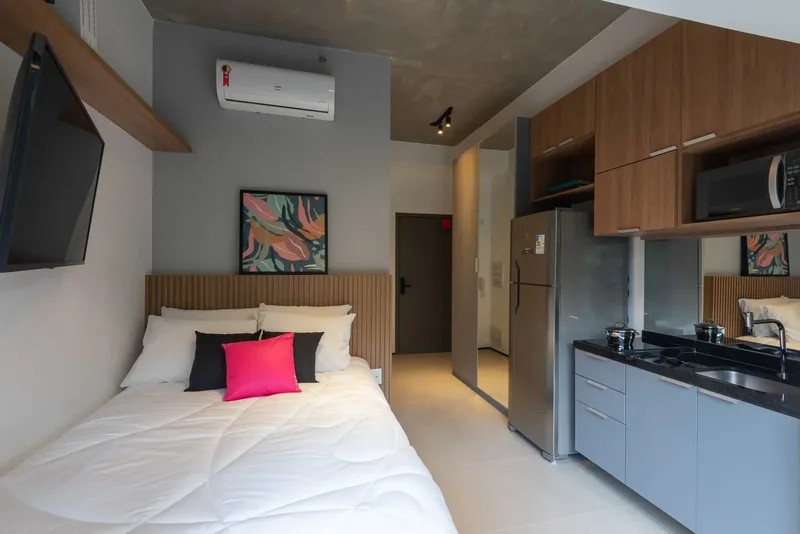 Studio decorated by Housi with bed, mirrored wardrobe and kitchenette in the same room