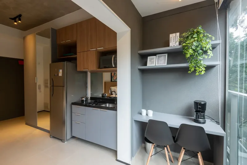Equipped kitchenette next to the work corner of the decorated studio