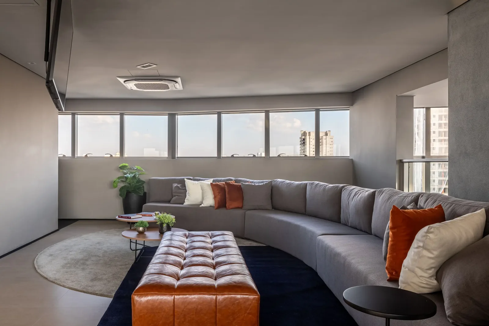 Cine lounge with curved sofa and city view