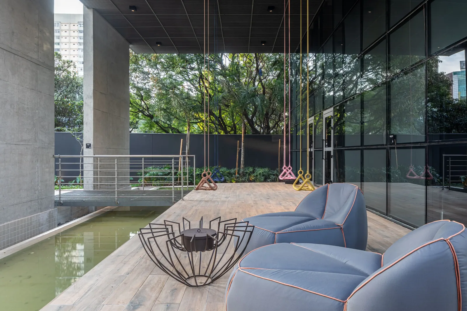 Outdoor lounge with reflecting pool and hanging swings